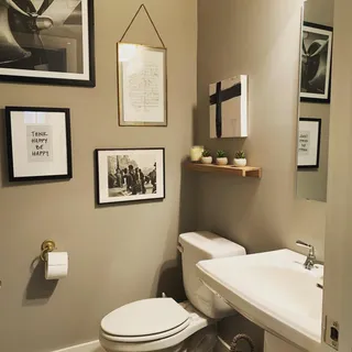 a white toilet sitting next to a bathroom sink