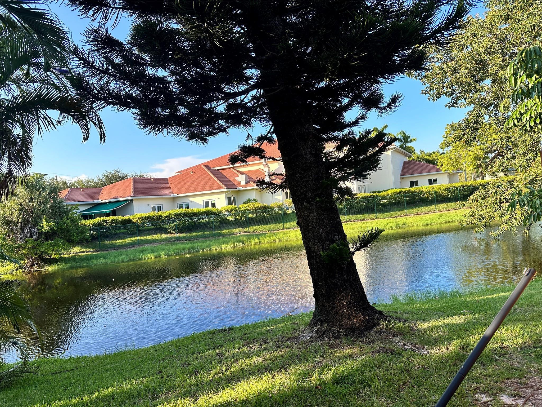 Undisclosed Address Sunrise, FL 33351 - Photo 7 of 16 a view of a lake from a yard