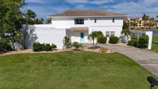 a front view of a house with a yard and potted plants
