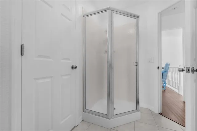a bathroom with a glass shower door