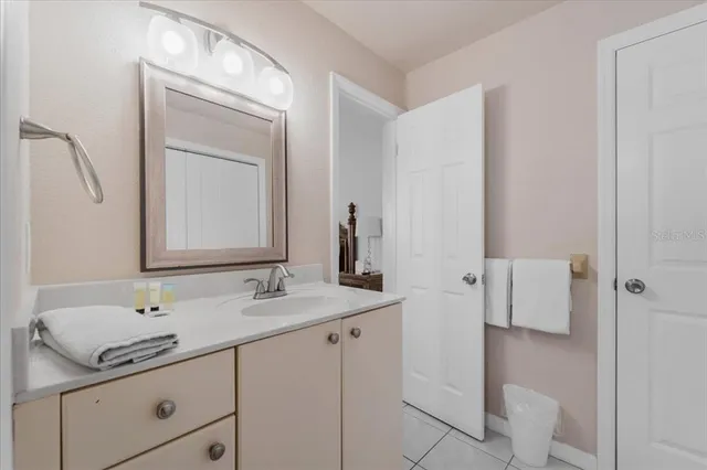 a bathroom with a granite countertop sink a toilet and a mirror