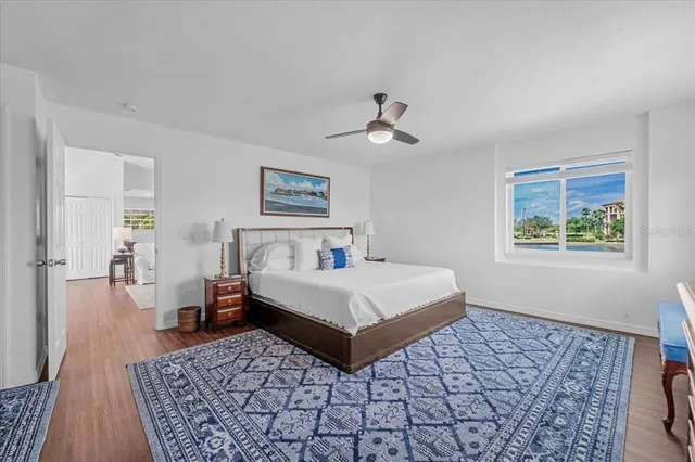 a bedroom with a bed lamp and a rug