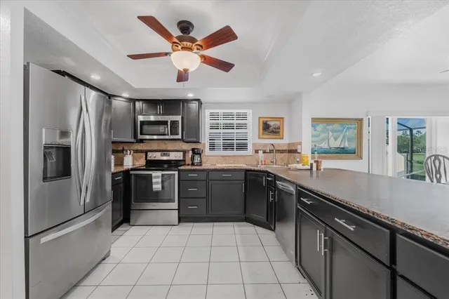 a large kitchen with cabinets and stainless steel appliances
