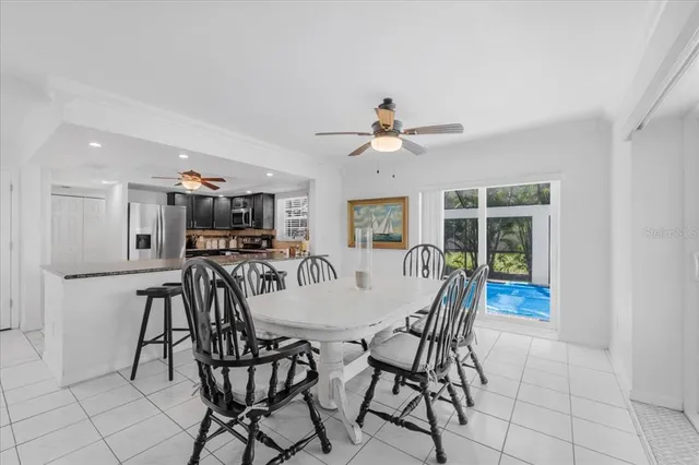 a view of a dining room with furniture and a chandelier