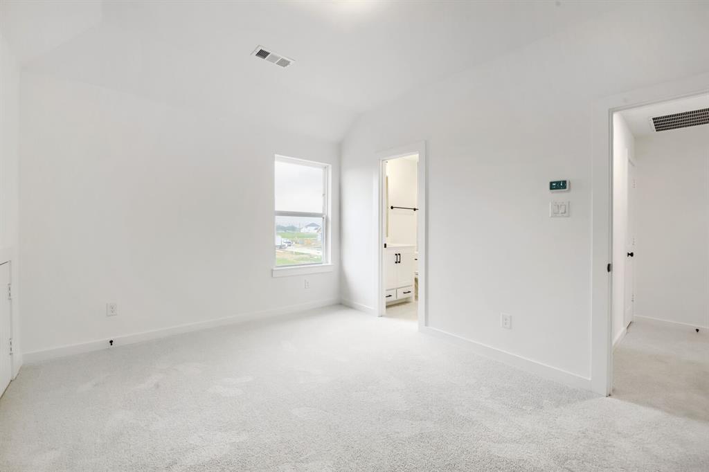 733 Red Cedar Road Haslet, TX 76052 - Photo 15 of 28 Vaulted ceiling room with light-colored carpeting, white baseboards, and a single-pane window