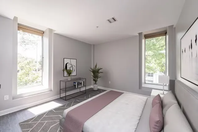a bedroom with a bed and a window