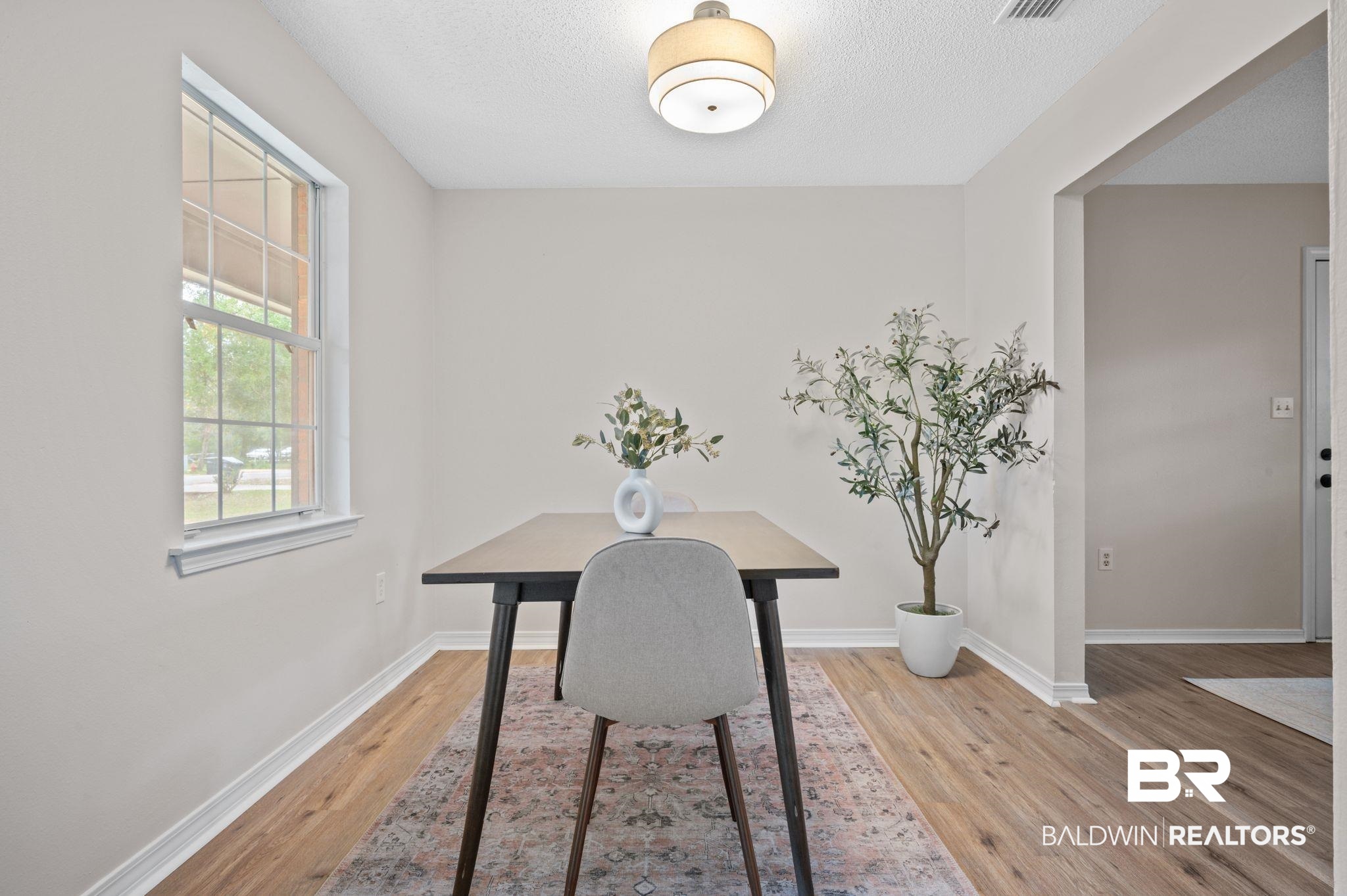 811 East Verbena Avenue Foley, AL 36535 - Photo 11 of 16 Dining room featuring a textured ceiling and light hardwood / wood-style floors