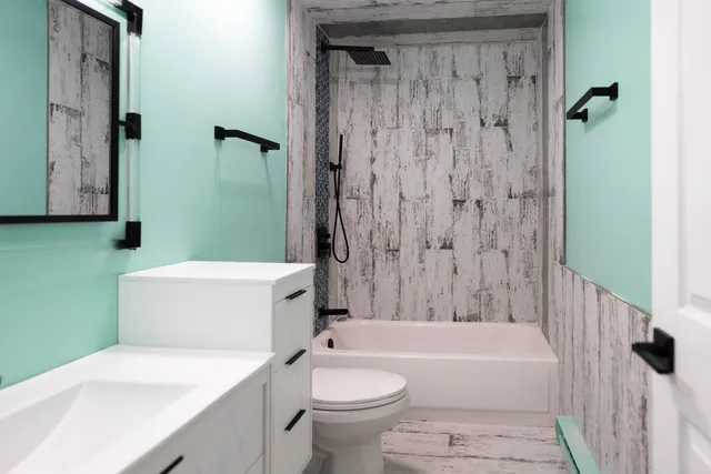 a bathroom with a sink a toilet and a bathtub