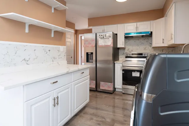 a kitchen with stainless steel appliances a refrigerator and a stove