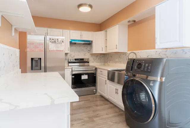 a kitchen with a stove top oven sink and cabinets