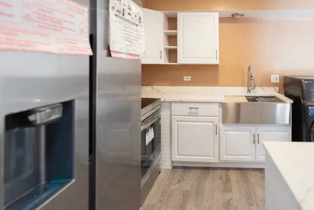 a bathroom with a sink a washer and dryer