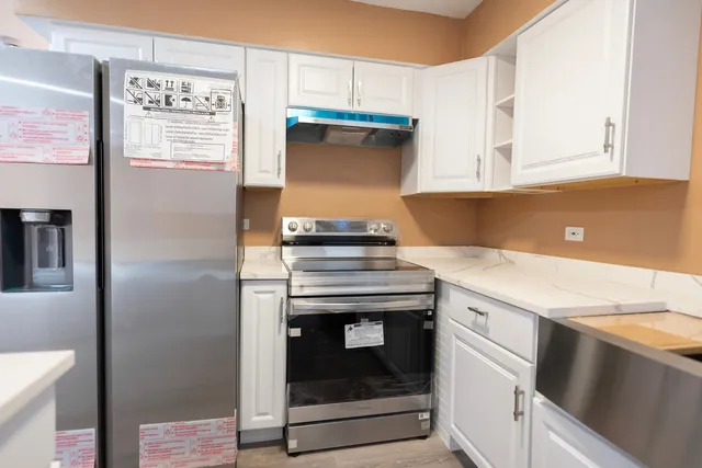 a kitchen with granite countertop a stove and a sink