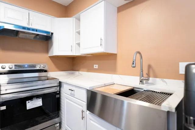 a kitchen with a sink and cabinets