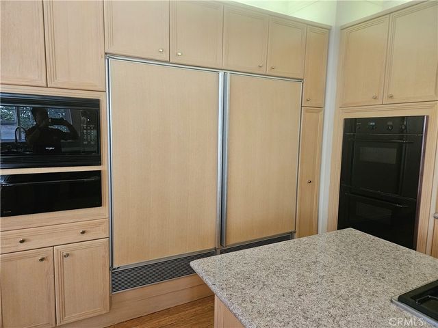 a view of a livingroom with wooden floor and a staircase