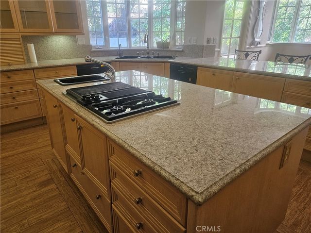 a kitchen with a sink and a mirror