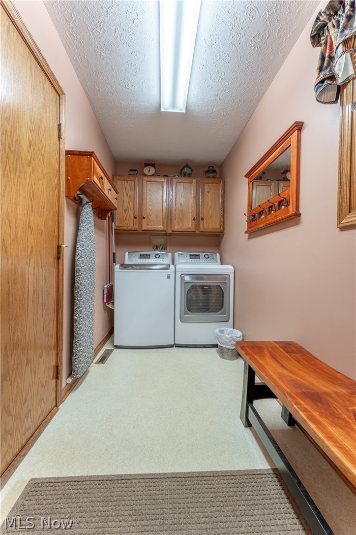 6341 Burbank Road Wooster, OH 44691 - Photo 18 of 36 Laundry area featuring cabinets, carpet, washer and clothes dryer, hookup for a washing machine, and a textured ceiling