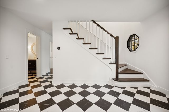 a view of a entryway with a checkered floor and white walls