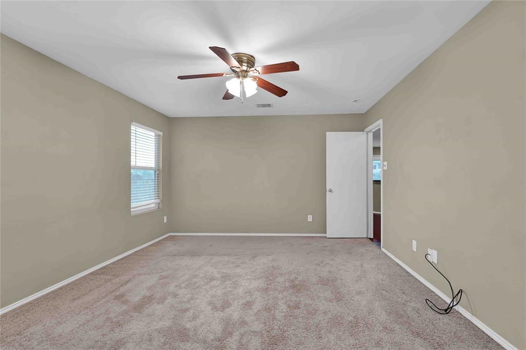 9517 George Washington Drive McKinney, TX 75072 - Photo 11 of 31 an empty room with windows and fan