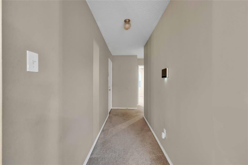 9517 George Washington Drive McKinney, TX 75072 - Photo 17 of 31 a view of a hallway with wooden floor