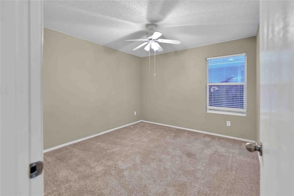 9517 George Washington Drive McKinney, TX 75072 - Photo 19 of 31 an empty room with a chandelier fan and windows