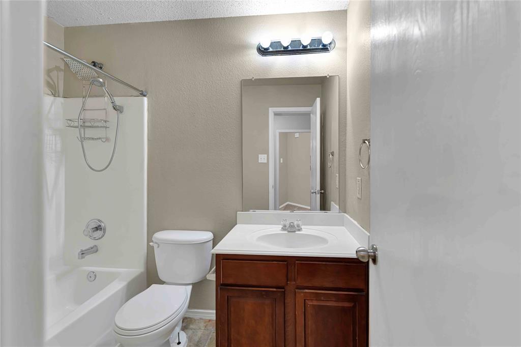 9517 George Washington Drive McKinney, TX 75072 - Photo 22 of 31 a bathroom with a sink a toilet and shower