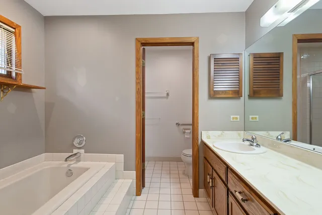 a bathroom with a tub sink and mirror