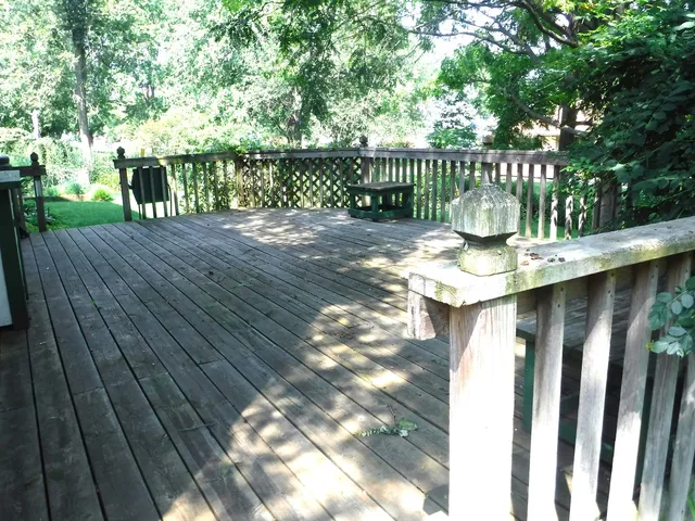 a view of a balcony with wooden floor