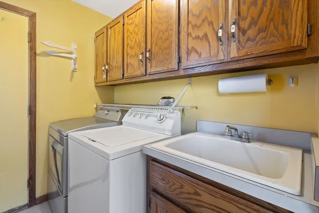 a utility room with a sink washer and dryer
