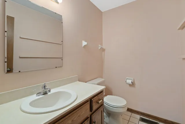 a bathroom with a sink toilet and a mirror