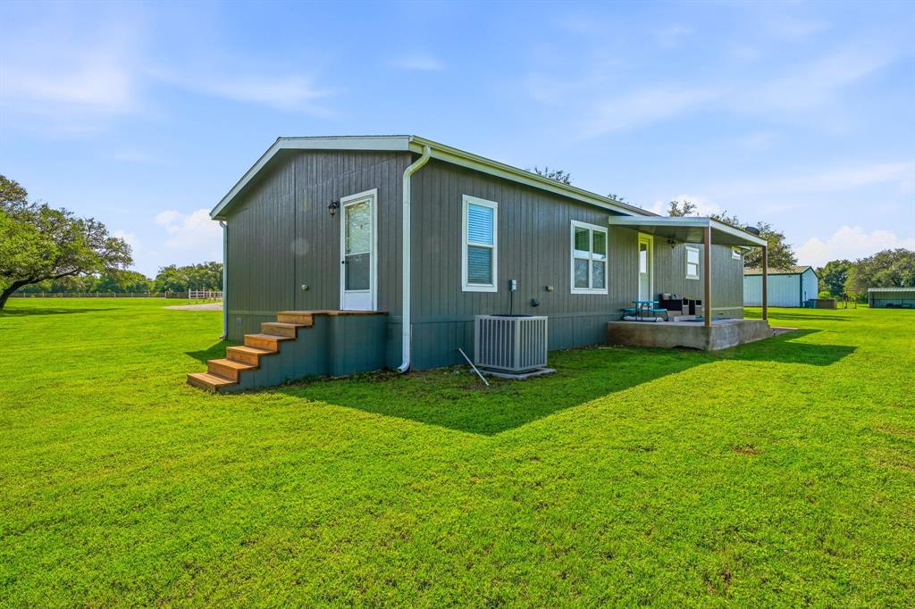 1262 Rosser Ranch Road Graham, TX 76450 - Photo 20 of 39 a view of a house with a yard and sitting area