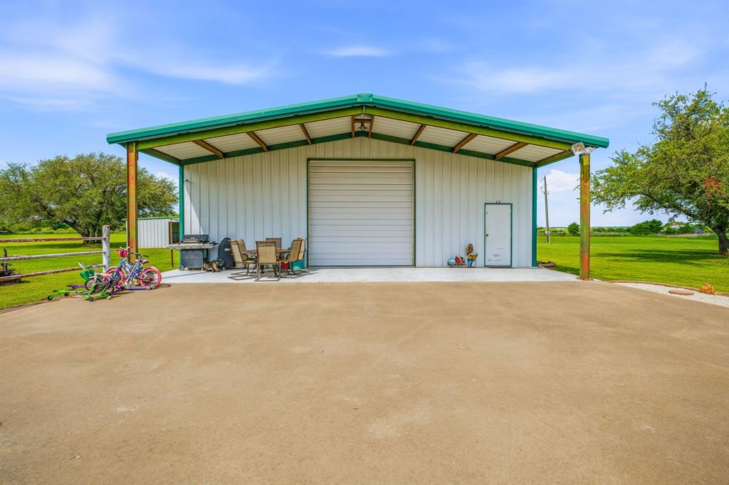 1262 Rosser Ranch Road Graham, TX 76450 - Photo 24 of 39 a front view of a house with a yard and garage