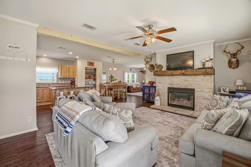 1262 Rosser Ranch Road Graham, TX 76450 - Photo 3 of 39 a living room with furniture a fireplace and a flat screen tv
