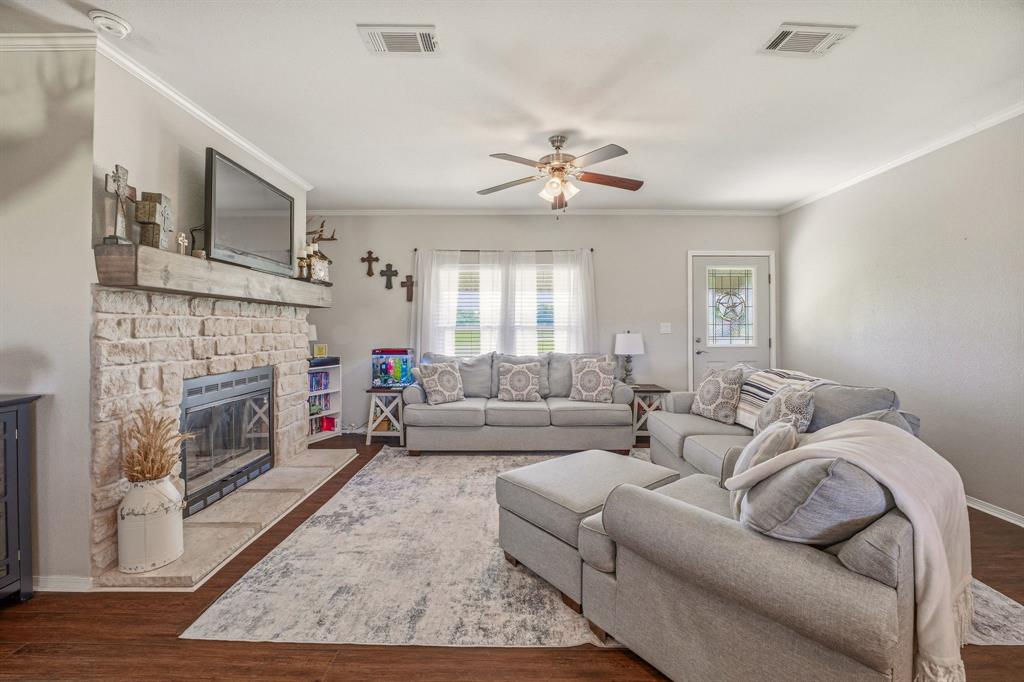 1262 Rosser Ranch Road Graham, TX 76450 - Photo 4 of 39 a living room with furniture a fireplace and a flat screen tv