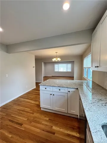 a kitchen with granite countertop a sink and a stove