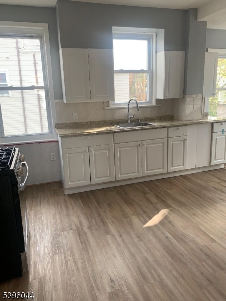 260 Pacific Street, Unit 2 Paterson, NJ 07503 - Photo 5 of 12 a kitchen with granite countertop a sink and a stove