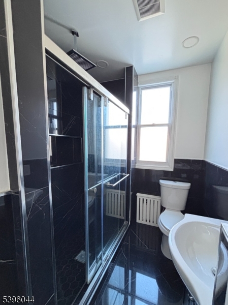 260 Pacific Street, Unit 2 Paterson, NJ 07503 - Photo 10 of 12 a bathroom with a sink and mirror