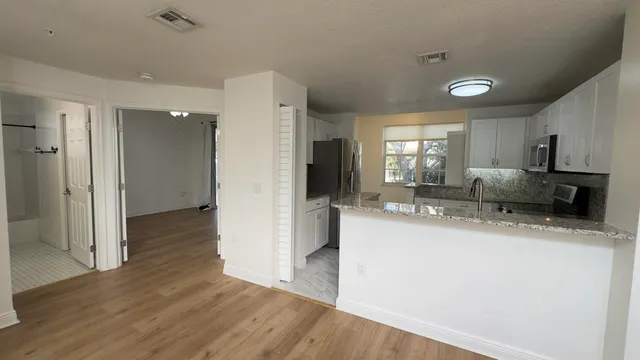 a kitchen with a refrigerator a sink and a stove top oven