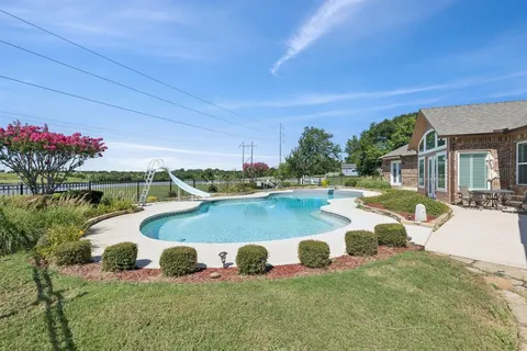 an aerial view of a house with outdoor space