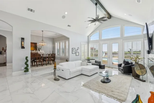 a living room with furniture and a chandelier