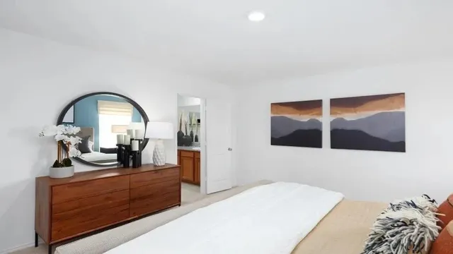 a view of bedroom with a large bed and dresser