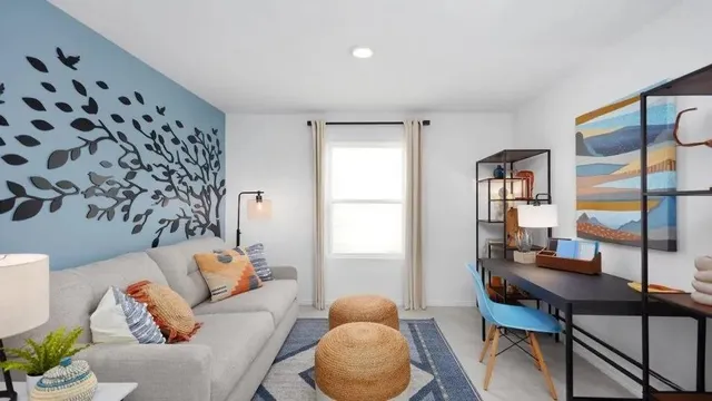 a living room with furniture and wooden floor