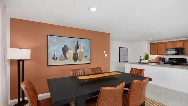 a kitchen with granite countertop kitchen island a sink table and chairs