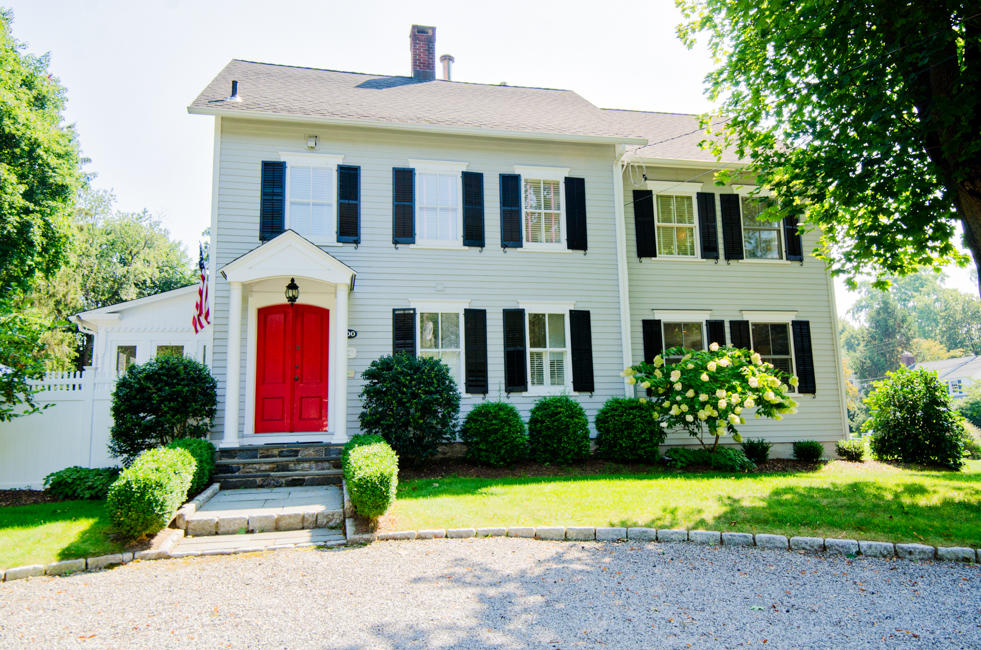 a front view of multi story residential apartment building with yard and green space