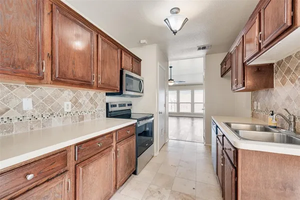 a kitchen with a sink stove and microwave
