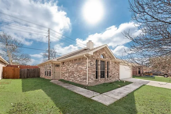 a view of a house with a yard and a fence