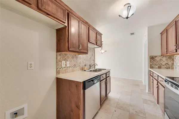 a kitchen with a sink and a refrigerator