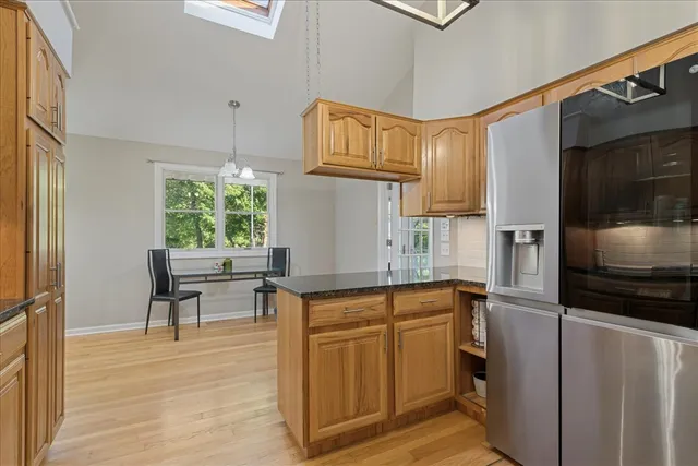 a kitchen with stainless steel appliances granite countertop a refrigerator sink and cabinets