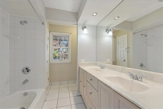 a spacious bathroom with a granite countertop sink mirror and shower
