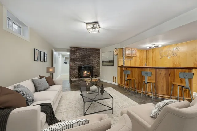 a living room with furniture a fireplace and a flat screen tv