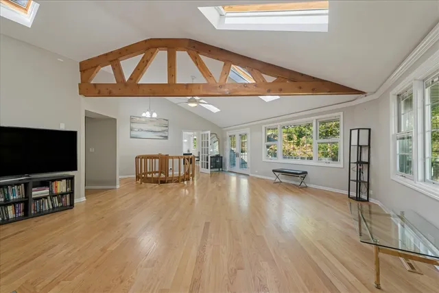 a view of a livingroom with furniture a flat screen tv and staircase